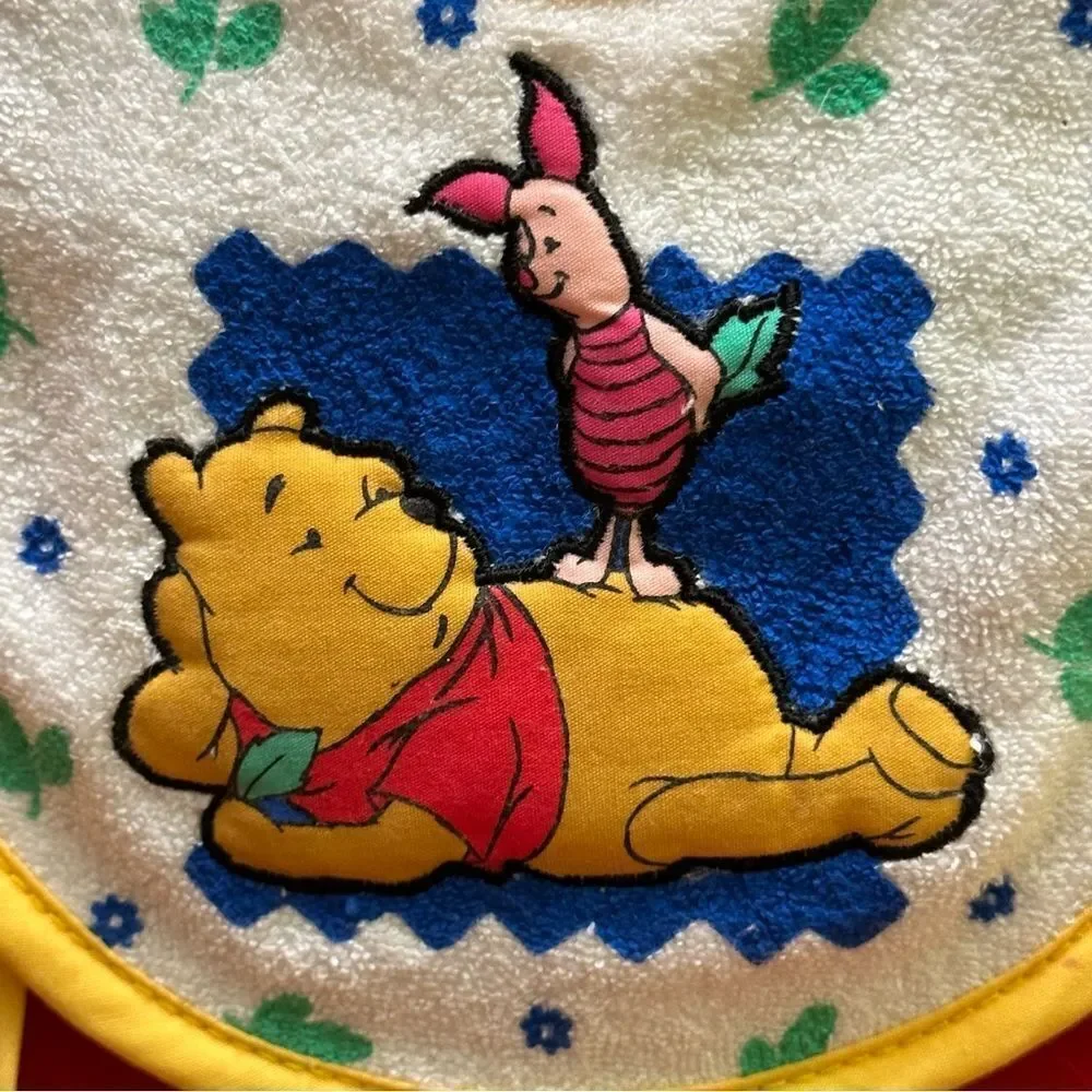 The first years Pooh Tie Bib Newborn